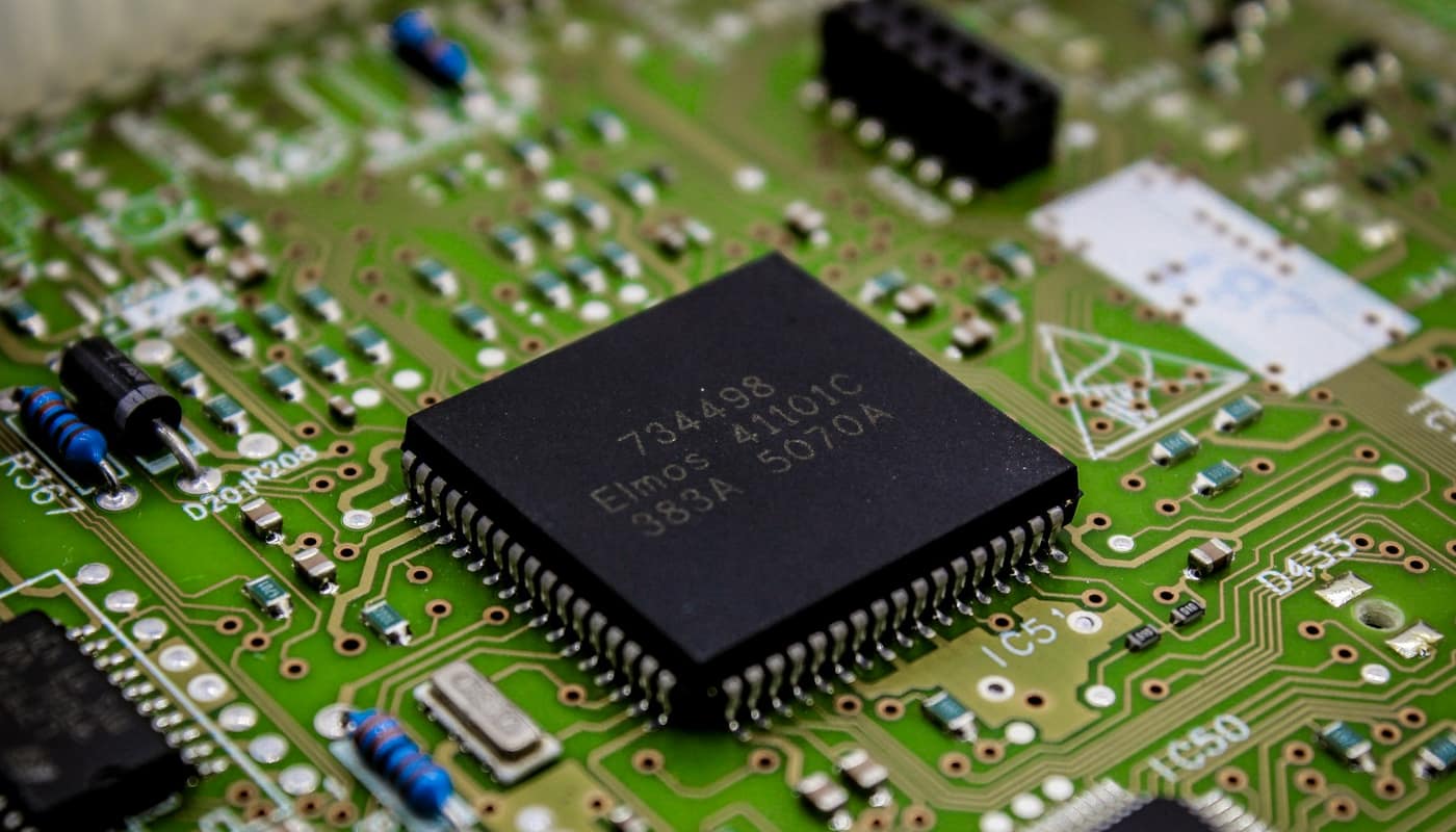 A microchip on a green circuit board
