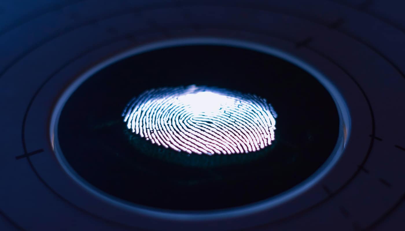 A glowing fingerprint on a circular scanner